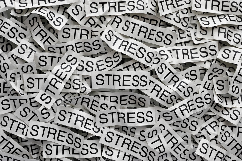 the word stress written thousands of times on little pieces of white paper